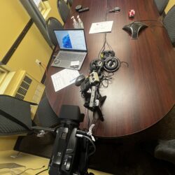 Deposition recording gear in use on conference room table