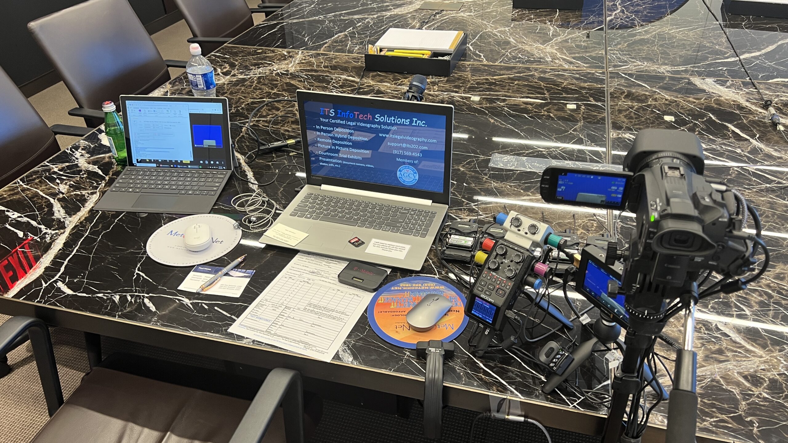 Deposition recording gear in use on conference room table