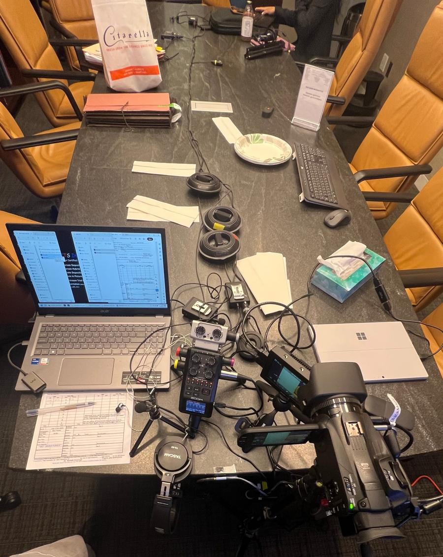Deposition recording gear in use on conference room table