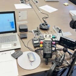 Deposition recording gear in use on conference room table
