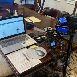 Deposition recording gear in use on conference room table